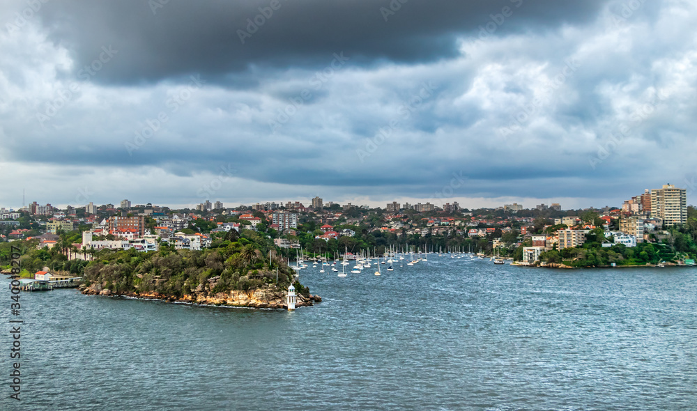 Panoramic view of the Robertsons Point Lighthouse under a dramatic cloudy sky in Sydney, Australia.