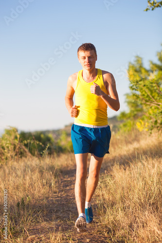 Young man jogging in park. Health and fitness. © aeroking