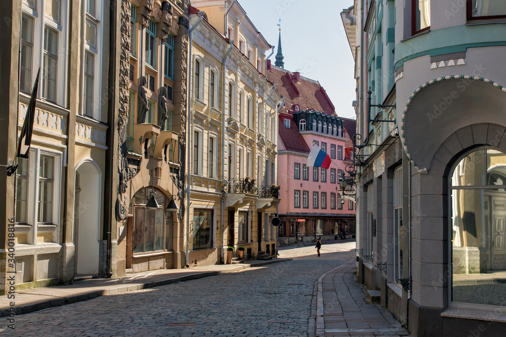 beautiful and picturesque Long street (Pikk) in the city of old Tallinn. Architectural facade. Medieval architecture of Estonia. Colorful buildings. Spring season in Europe.