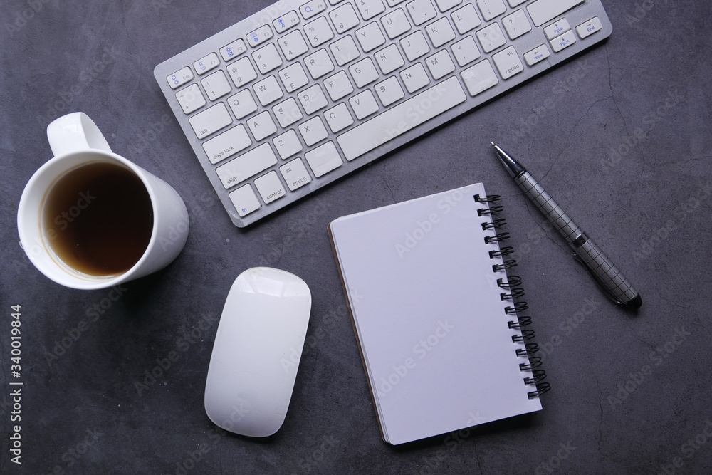 high angle view of notepad keyboard and mouse on table high angle view of notepad keyboard and mouse on table