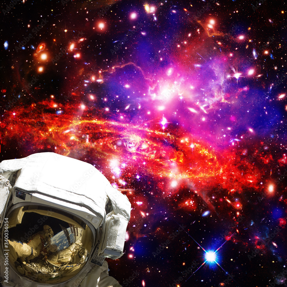 Astronaut and galaxy on the backdrop. The elements of this image furnished by NASA. Astronaut and galaxy on the backdrop. The elements of this image furnished by NASA.