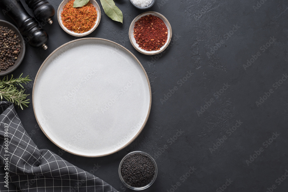 Gray platter and spices for cooking and marinade. Space for text. View from above. Gray platter and spices for cooking and marinade. Space for text. View from above.