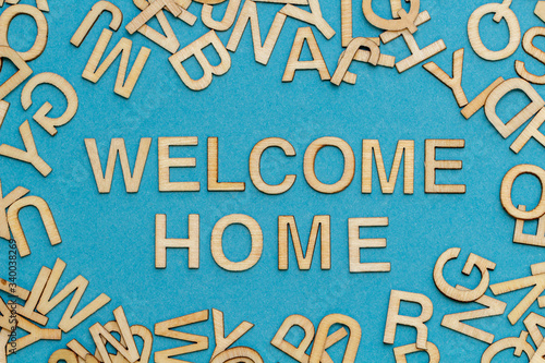 wooden letters WELCOME HOME on blue background