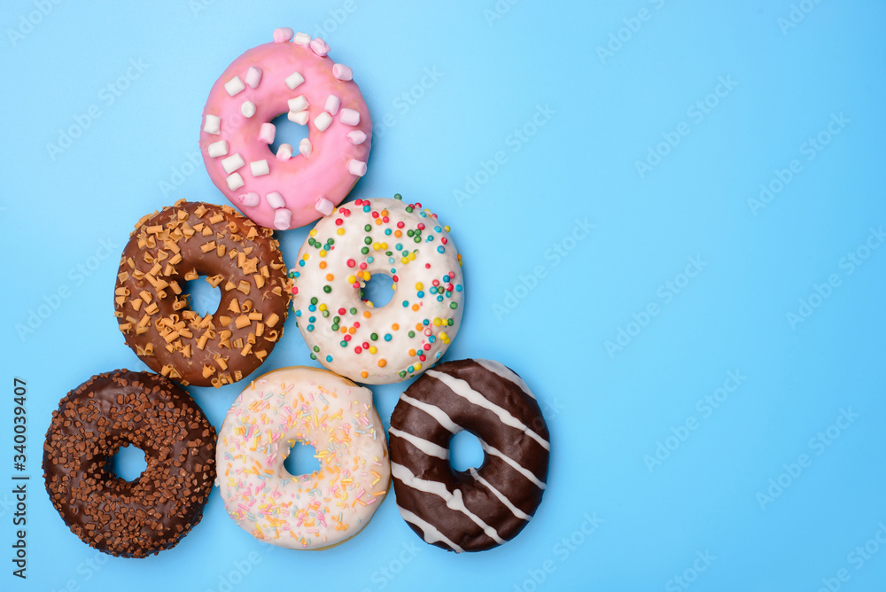 Present Christmas gift concept. Top above overhead flat-lay flatlay close up photo of lot of funny joking donuts making winter tree isolated over vivid blue background copy space Present Christmas gift concept. Top above overhead flat-lay flatlay close up photo of lot of funny joking donuts making winter tree isolated over vivid blue background copy space