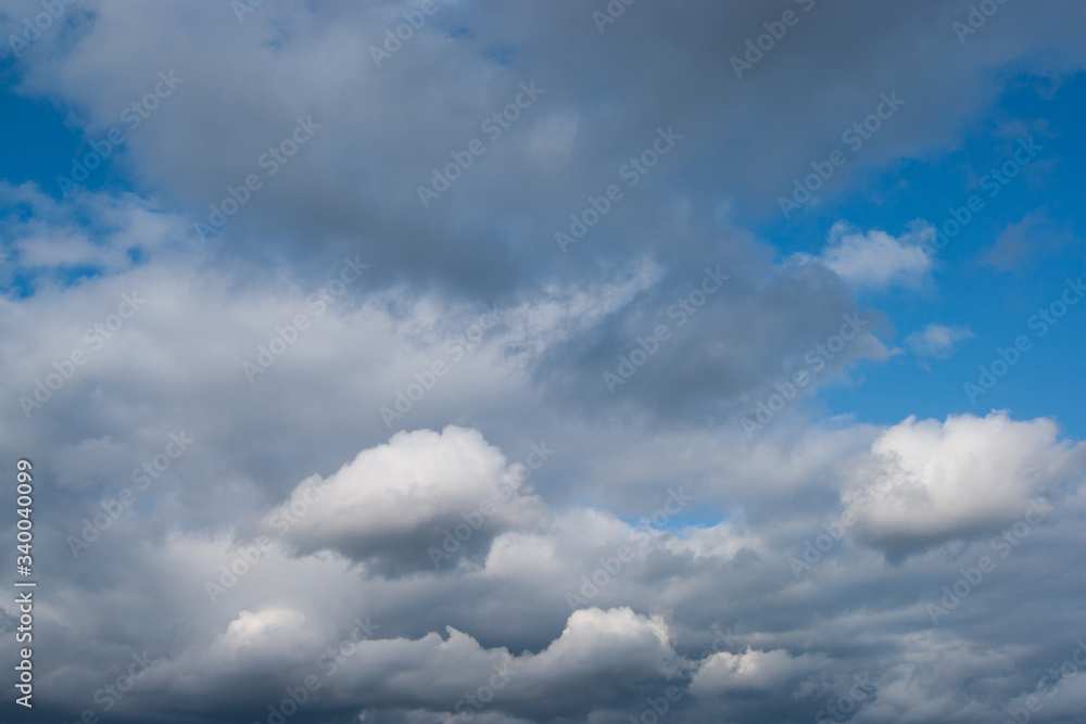 Cloudy sky In the photo on the blue sky are heavy thick white clouds. Thick cloud cover. Cloudy sky In the photo on the blue sky are heavy thick white clouds. Thick cloud cover.