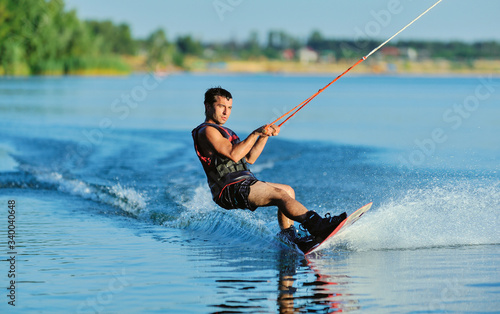 Wakeboarder surfing across a lake