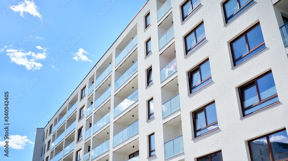 Modern apartment buildings on a sunny day with a blue sky. Facade of a modern apartment building Modern apartment buildings on a sunny day with a blue sky. Facade of a modern apartment building