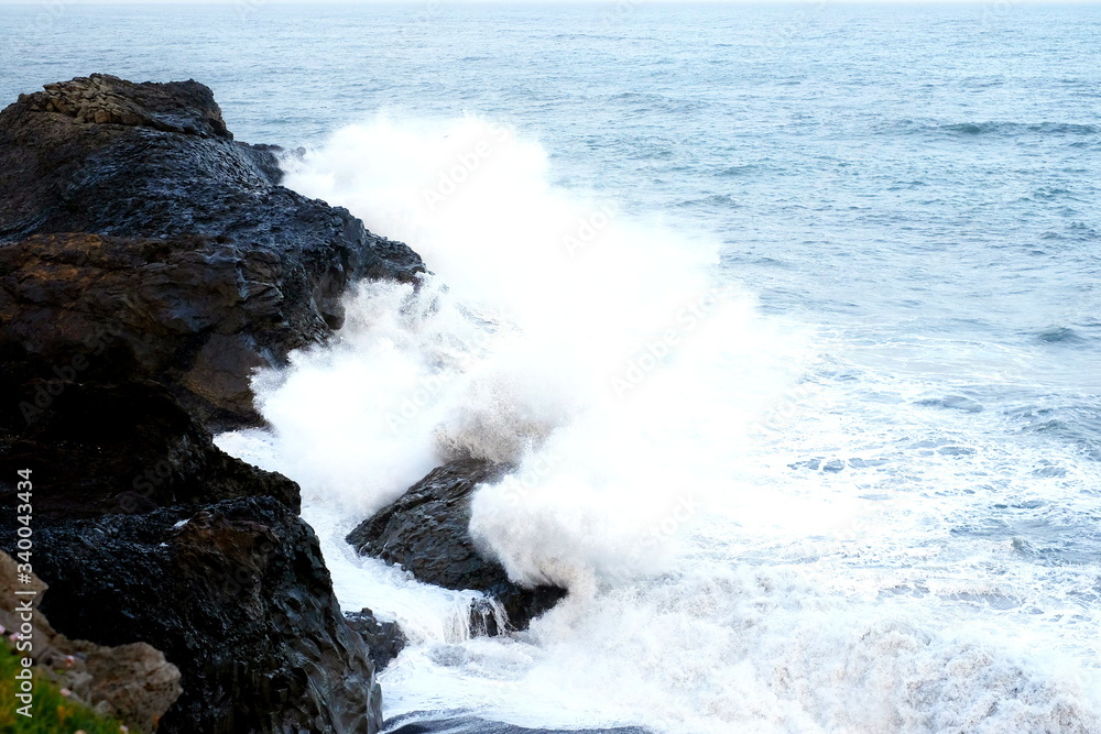 The ocean is breaking on the rocks The ocean is breaking on the rocks