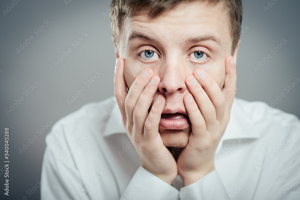Young desperate man head in his hands clasped. Young desperate man head in his hands clasped.