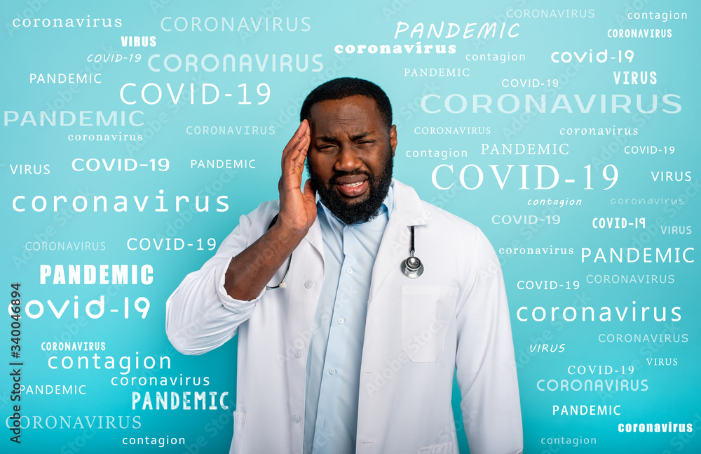 Doctor is exhausted due to overwork by coronavirus covid-19. Cyan background Doctor is exhausted due to overwork by coronavirus covid-19. Cyan background