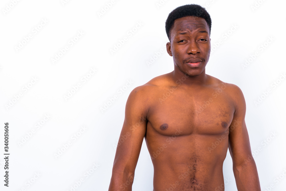 Young handsome African man shirtless against white background Young handsome African man shirtless against white background