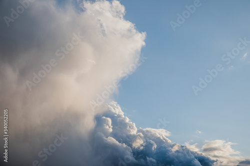 Bright blue cumulus clouds with silver lining background