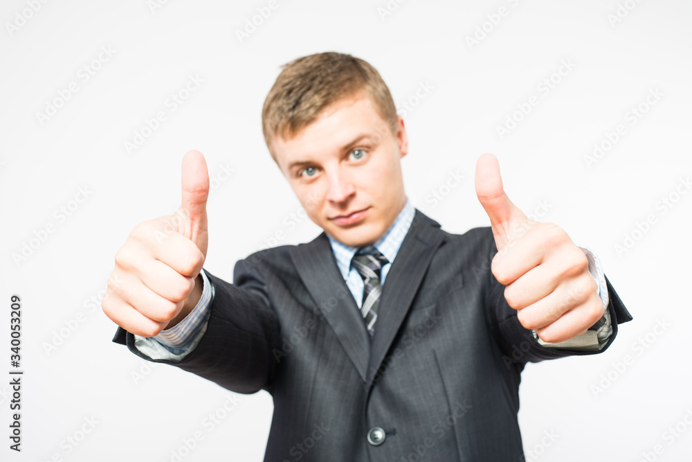 A well-dressed businessman shows thumb up A well-dressed businessman shows thumb up