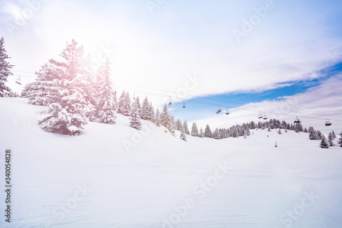 Alpine ski lift and snow covered firs Mont-Blanc, Chamonix region, Auvergne-Rhone-Alpes in south-eastern France