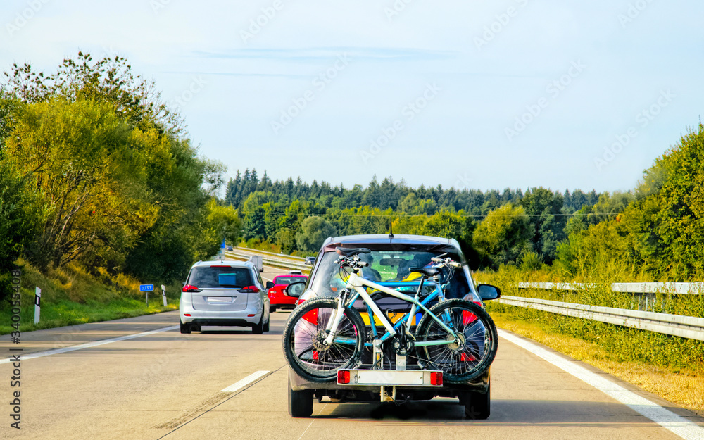 Car with bicycles in highway at Switzerland reflex