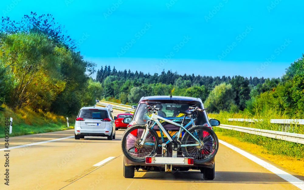 Car with bicycles in highway in Switzerland reflex