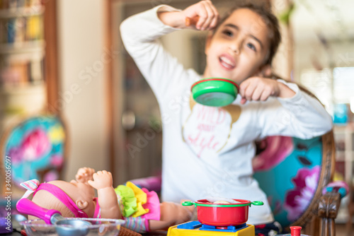 little girl plays cooking