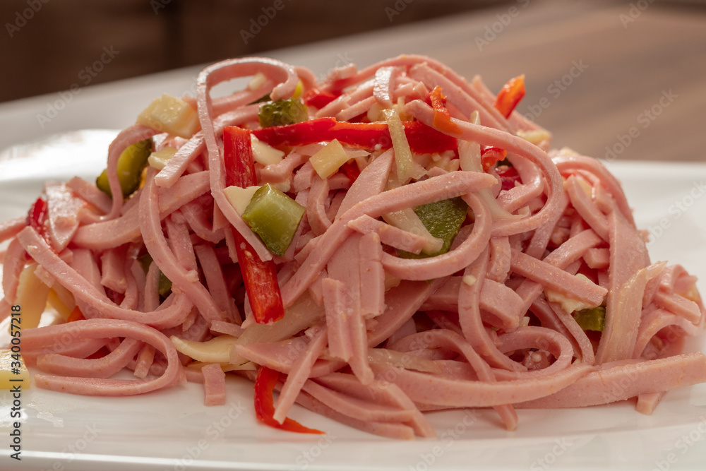 Hearty sausage salad with cheese strips and pickles Hearty sausage salad with cheese strips and pickles