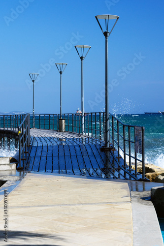 A popular place for walking along the Limassol seafront Molos Beach on a bright sunny day.