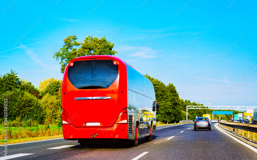 Red Tourist bus on road in Poland reflex