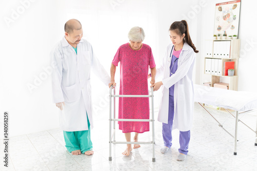 walk training and rehabilitation process, old asian stroke patient learning to uses walker with female asian doctor in hospital, elderly healthcare promotion, walk training and rehabilitation  © jokekung