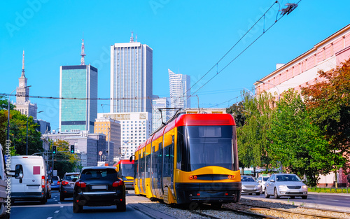 Trolley and cars on road in Warsaw city center reflex