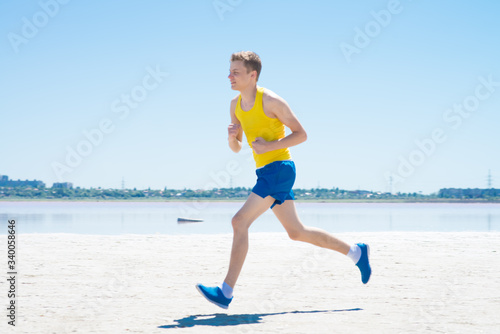 young man jogging on the beach in summer © aeroking