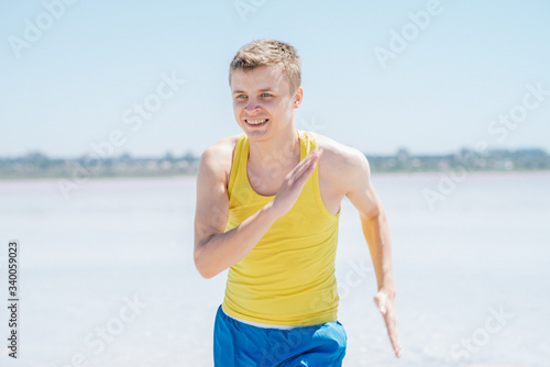 Athletic young male running on the beach