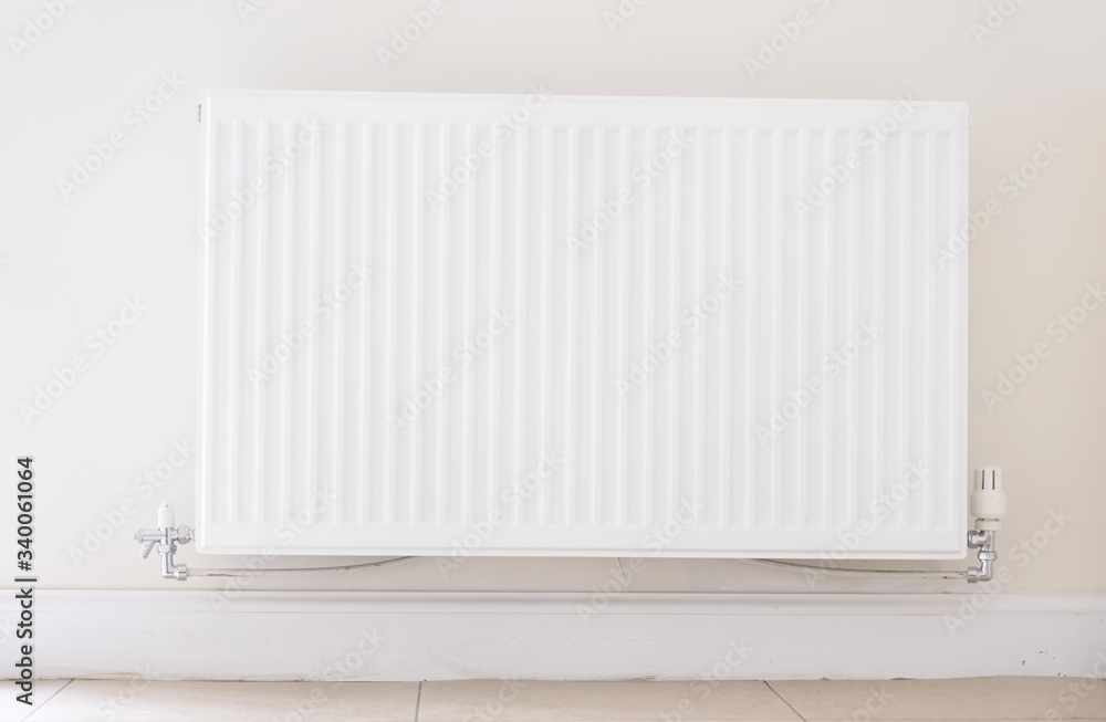 New white radiator white on pale wall house interior New white radiator white on pale wall house interior