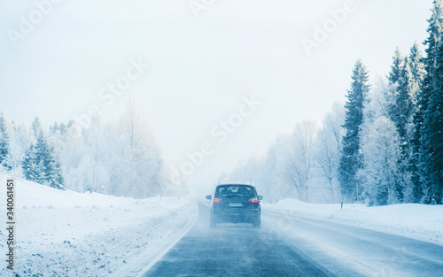 Car in a road a snowy winter Lapland reflex