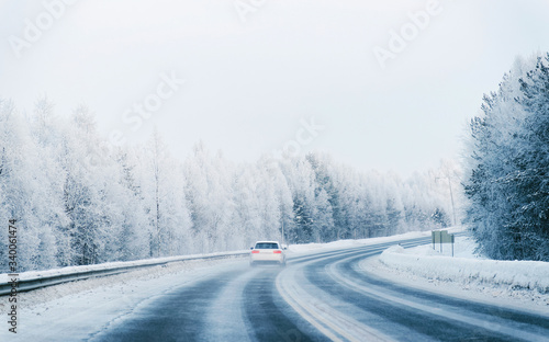 Car in a road at a snowy winter Lapland reflex © Roman Babakin