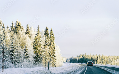 Landscape of car in road at snowy winter Lapland reflex