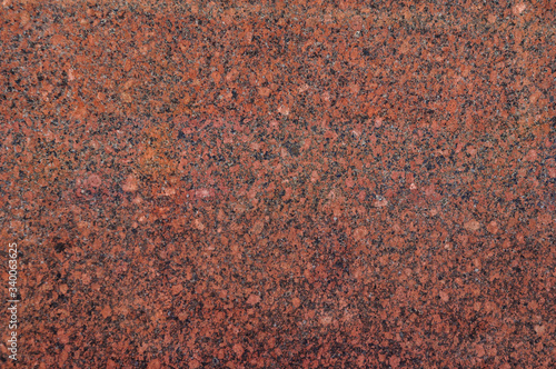 Texture of the polished surface of natural brown granite.