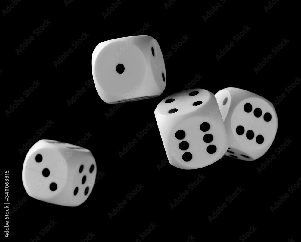 White playing, gambling die, dice for tabletop games and poker isolated on black background with clipping path White playing, gambling die, dice for tabletop games and poker isolated on black background with clipping path