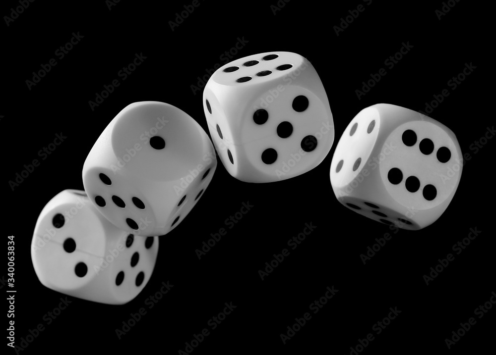 White playing, gambling die, dice for tabletop games and poker isolated on black background with clipping path White playing, gambling die, dice for tabletop games and poker isolated on black background with clipping path