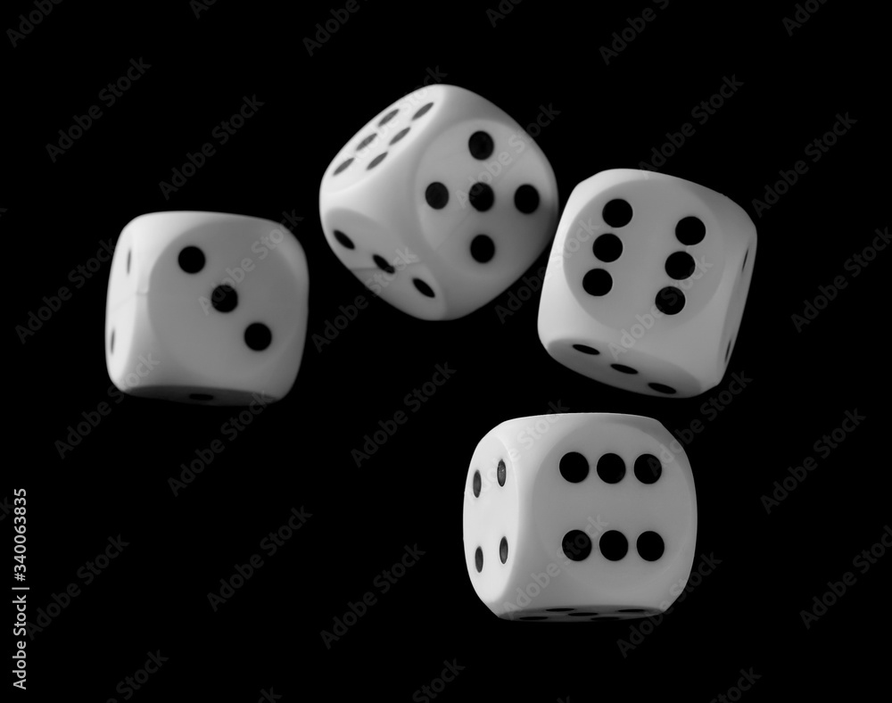 White playing, gambling die, dice for tabletop games and poker isolated on black background with clipping path White playing, gambling die, dice for tabletop games and poker isolated on black background with clipping path