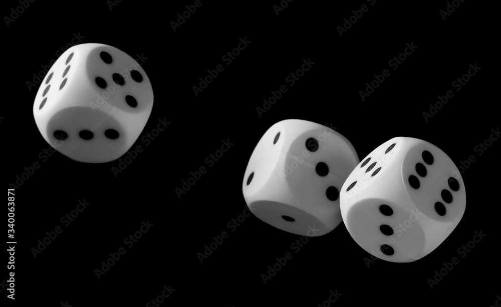 White playing, gambling die, dice for tabletop games and poker isolated on black background with clipping path White playing, gambling die, dice for tabletop games and poker isolated on black background with clipping path