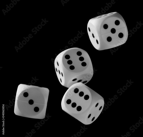White playing  gambling die  dice for tabletop games and poker isolated on black background with clipping path