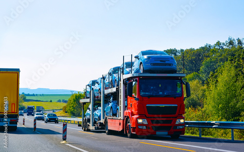 Cars carrier truck asphalt road Poland reflex