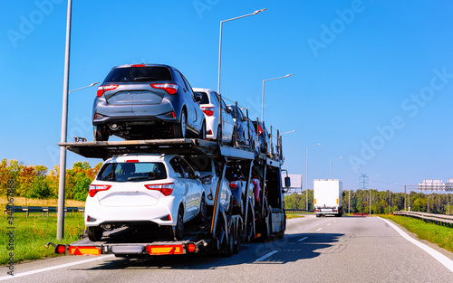 Cars carrier truck in asphalt road in Poland reflex