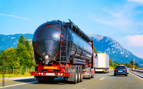 Black Tanker storage truck on asphalt highway Poland reflex