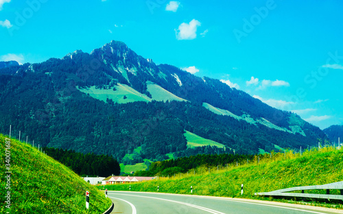 Road and Prealps mountains in Gruyere of Fribourg Switzerland reflex