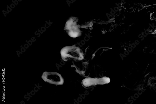 White isolated rings of smoke on black background