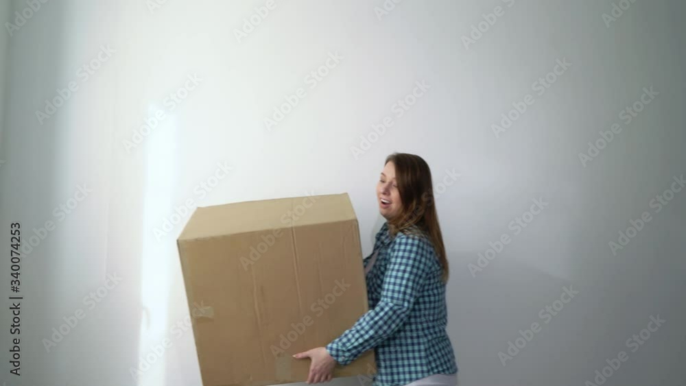 Woman with cardboard boxes, delivery girl holds and drops things.Falling storage Woman with cardboard boxes, delivery girl holds and drops things.Falling storage