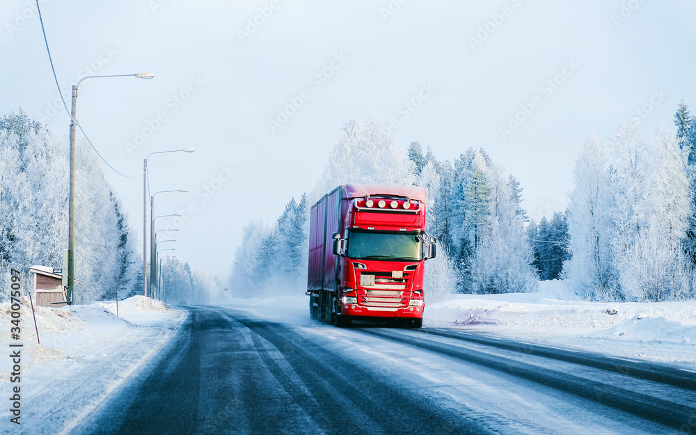 Obraz premium Truck at the Snowy winter Road in Finland Lapland reflex