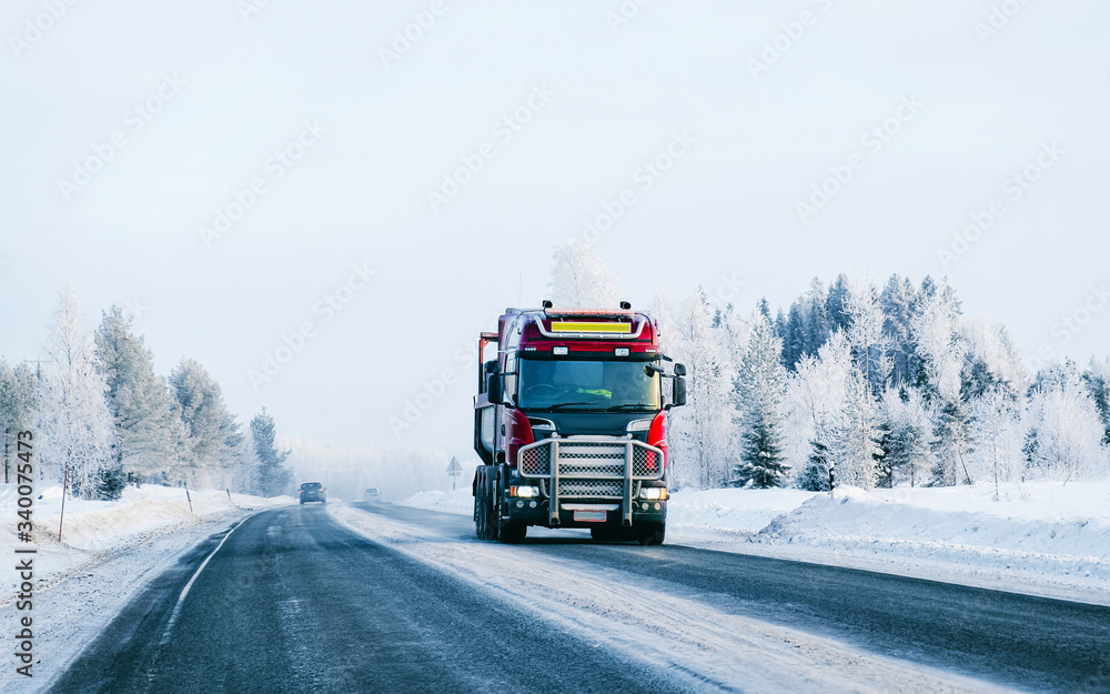 Truck in the Snowy winter Road in Finland Lapland reflex