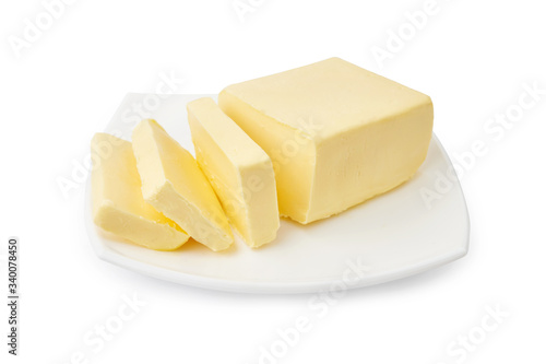 Sliced butter of piece butter on white plate isolated on white background.