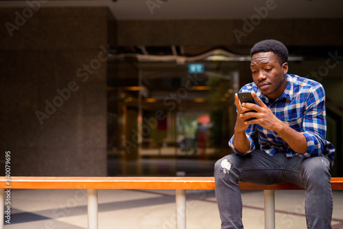 Young handsome African man exploring the city © Ranta Images