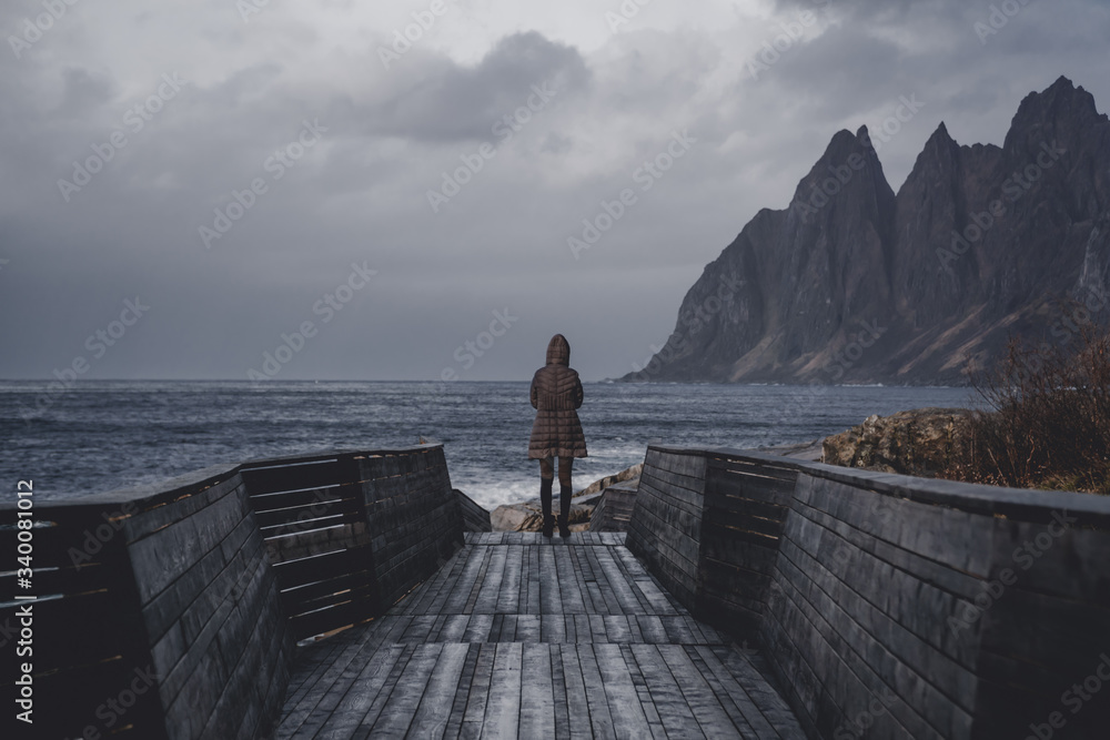 Women standing at the Tungeneset picnic on Senja - viewpoint and picnic area with its Nordic design structure nestled between the Steinfjord and the Ersfjord.