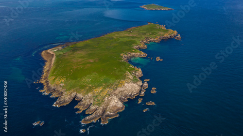 Aerial GREAT SALTEE ISLAND, IRELAND, Birds in Saltee islands and a boat near the isla